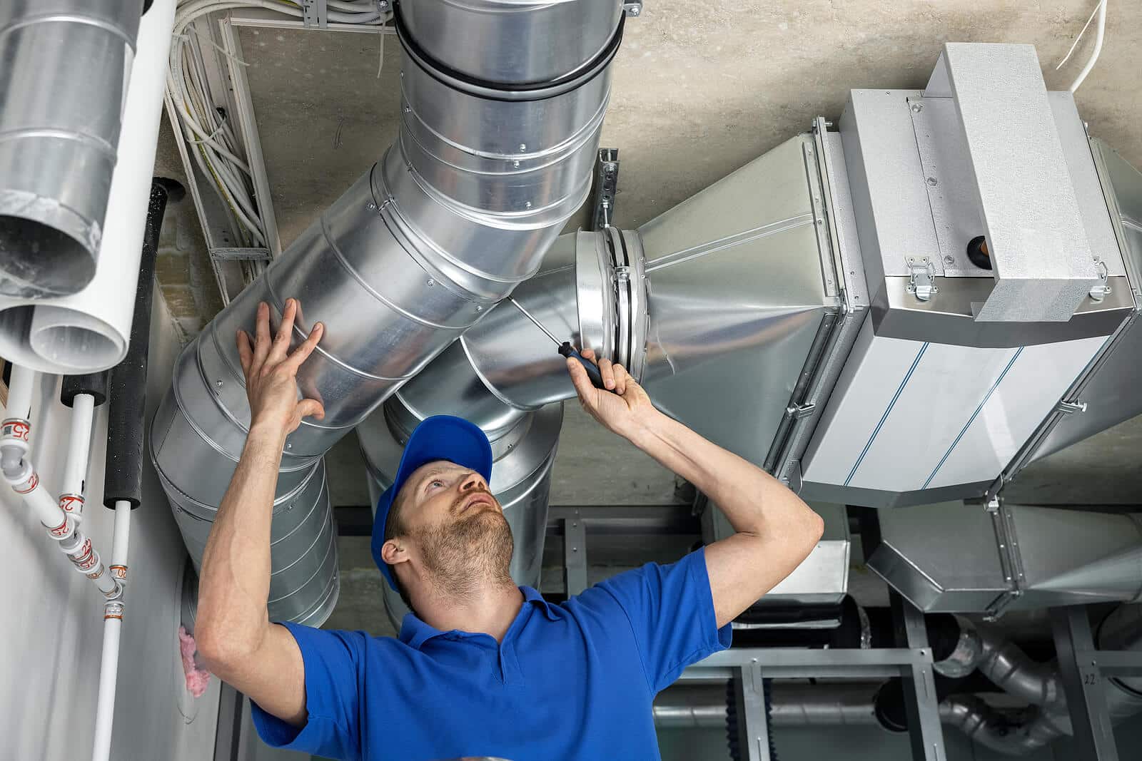 HVAC technician inspecting and repairing air ducts in Carmichael