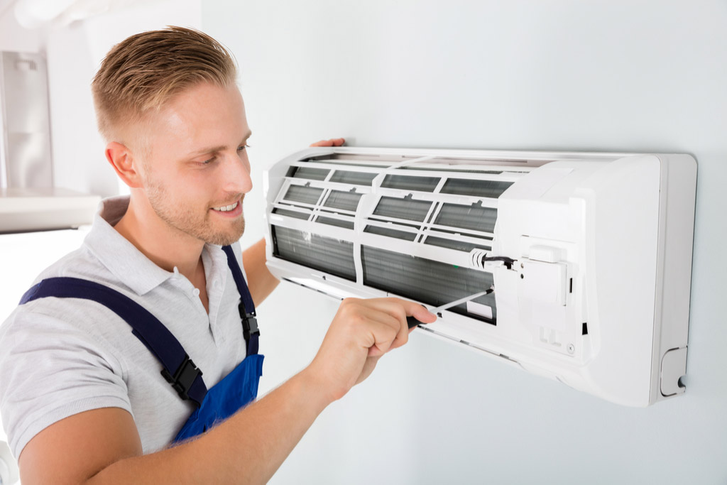 HVAC technician maintaining a ductless air conditioner in Carmichael