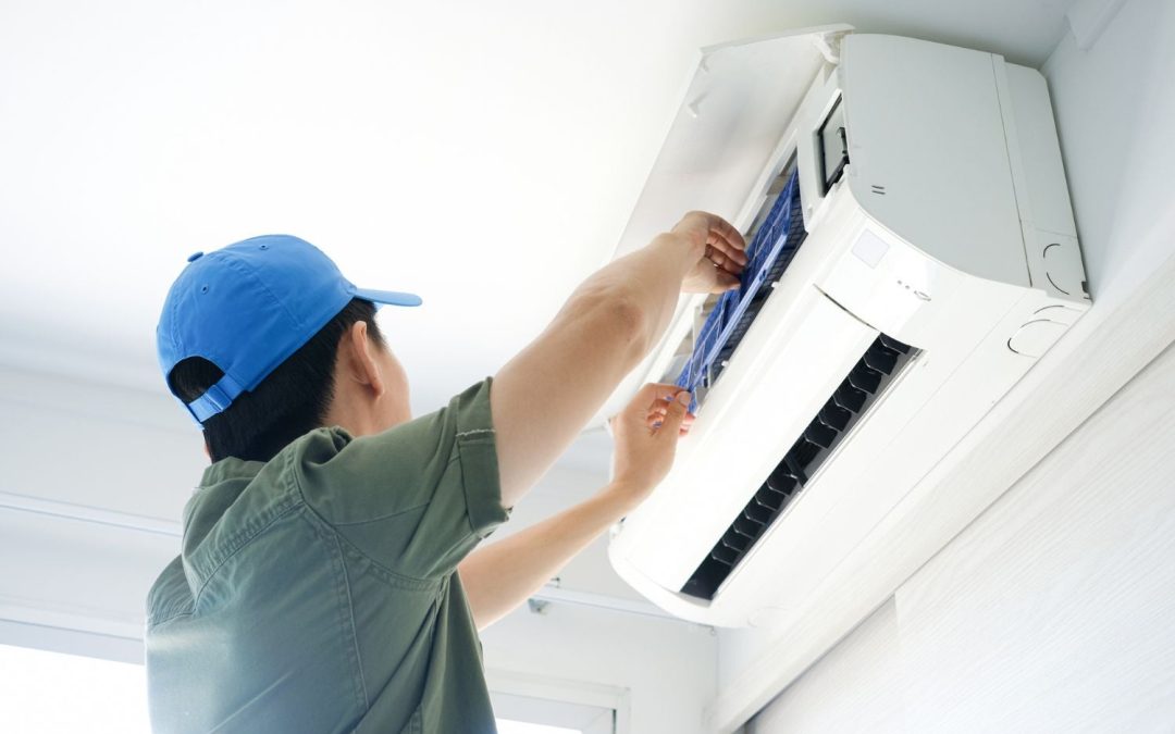 HVAC technician servicing a ductless mini split in Carmichael