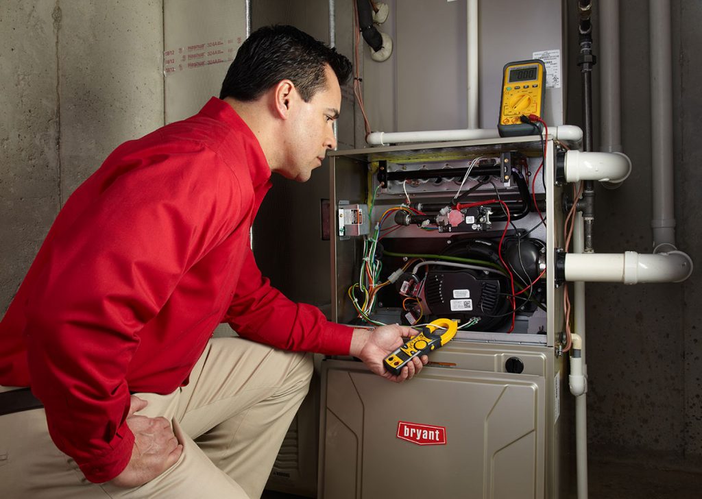 Heating technician diagnosing a furnace repair in Carmichael