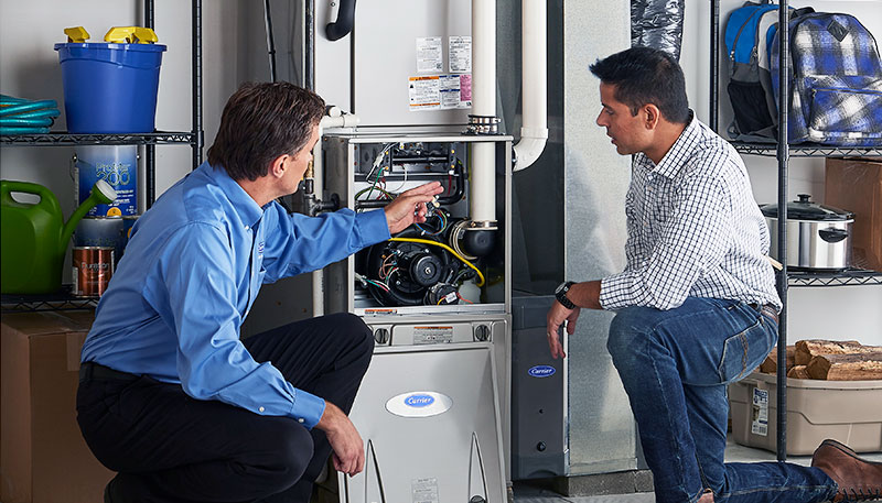 Technician evaluating a furnace for repair or replacement in Carmichael