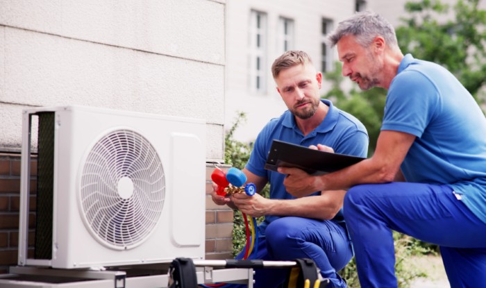 HVAC technicians installing an outdoor air conditioning unit in Carmichael