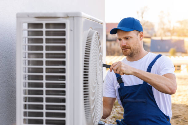 HVAC technician servicing an outdoor air conditioner in Carmichael