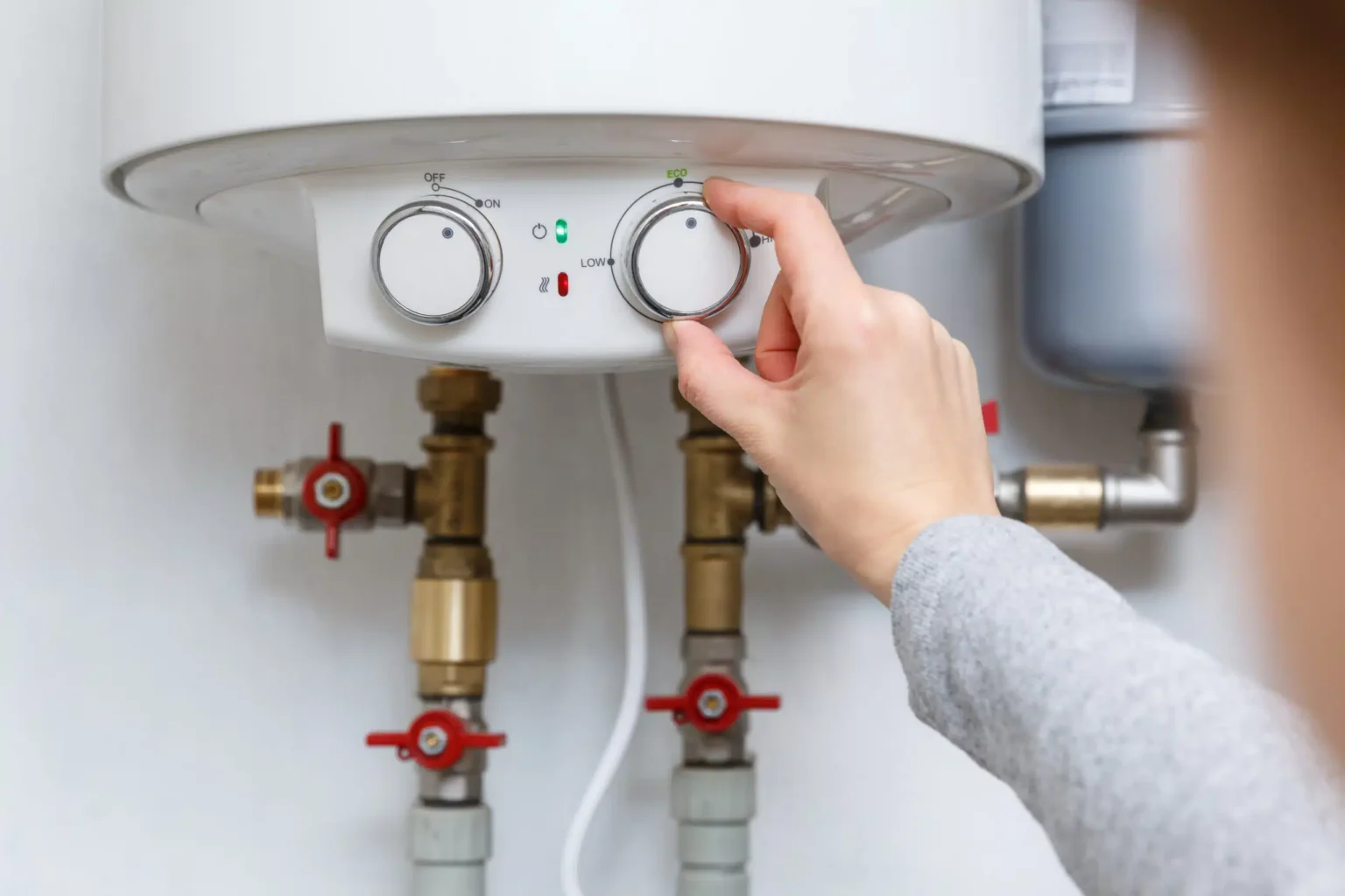 Technician adjusting a water heater in Carmichael